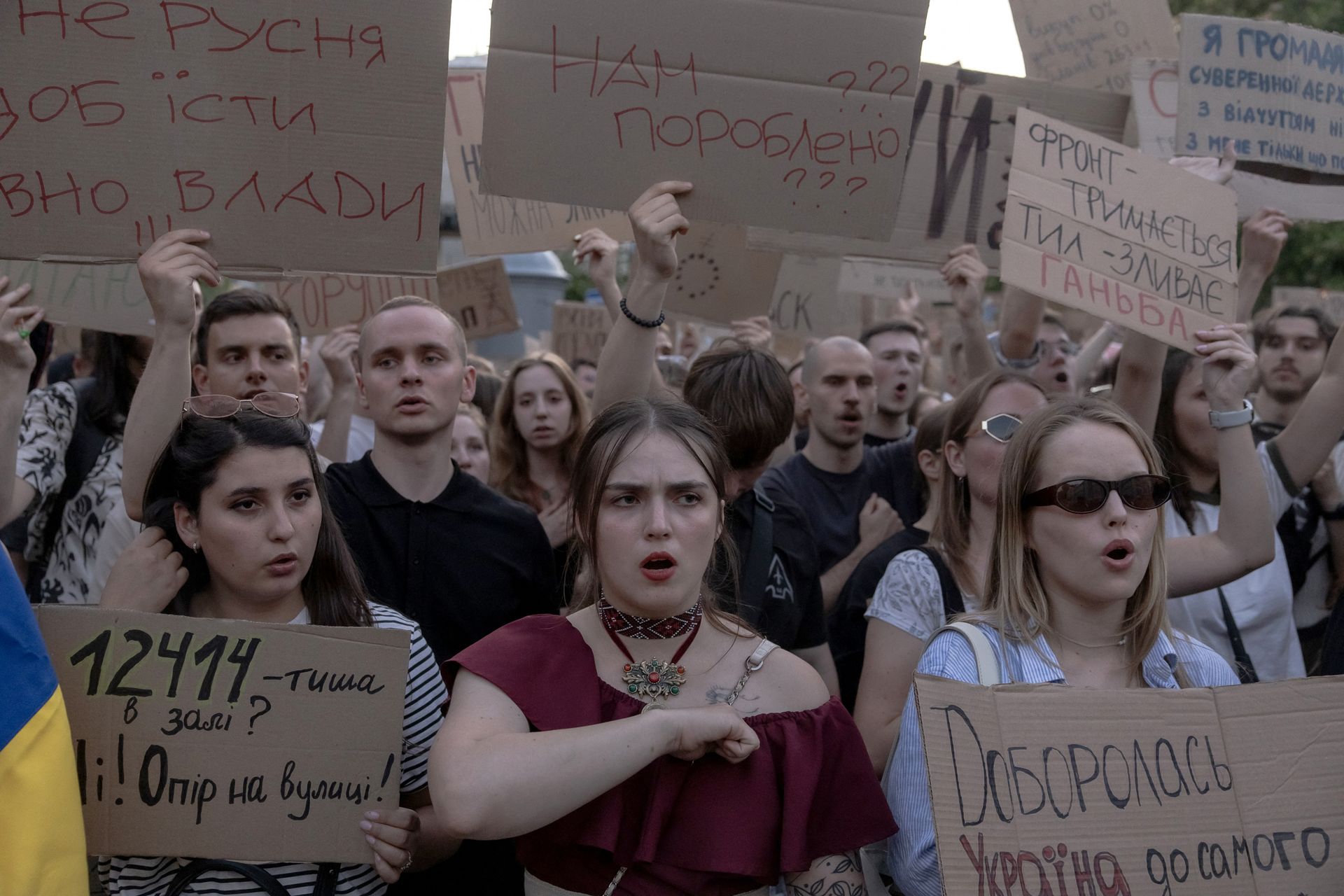 Protesters hold placards during a demonstration against a law removing the independence of two key anti-corruption bodies in downtown Kyiv, Ukraine, on July 23, 2025. 