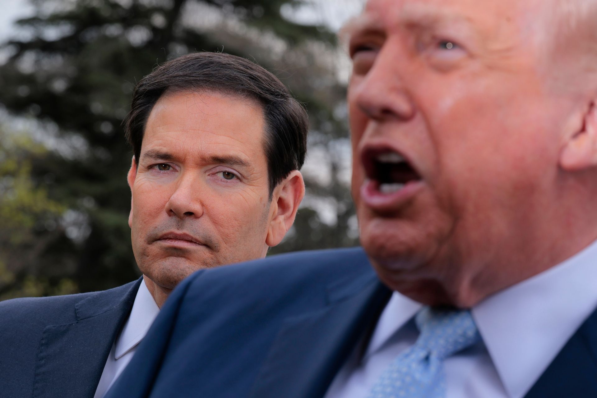 Secretary of State Marco Rubio (L) stands alongside U.S. President Donald Trump (R) before departing the White House for Mar-a-Lago in Washington, D.C., U.S. on March 20, 2026.
