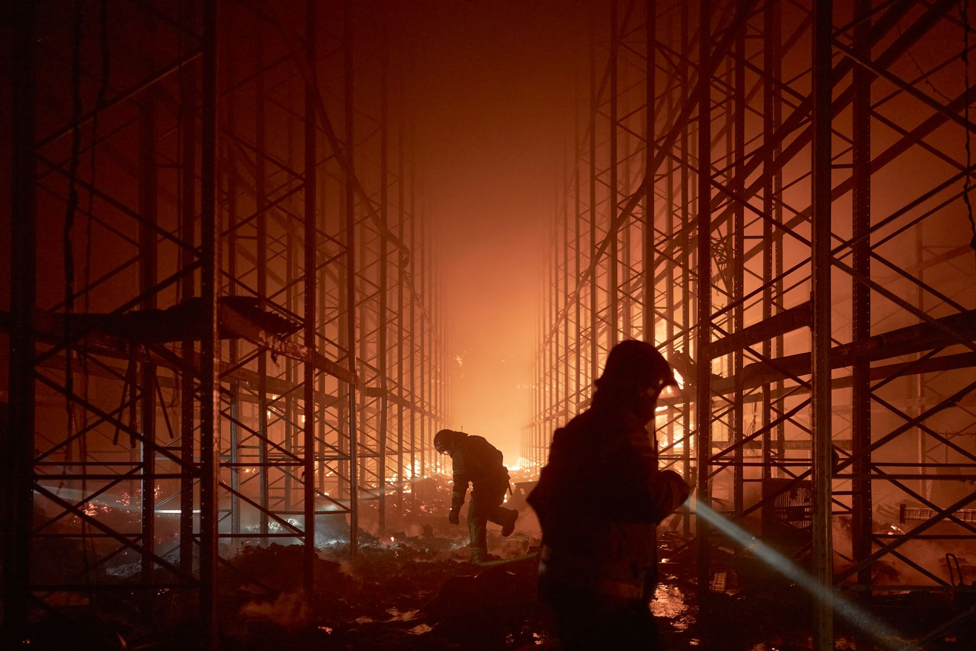 Emergency workers respond to a Russian strike on a Kyiv-region warehouse during the sustained overnight barrage into Aug. 31
