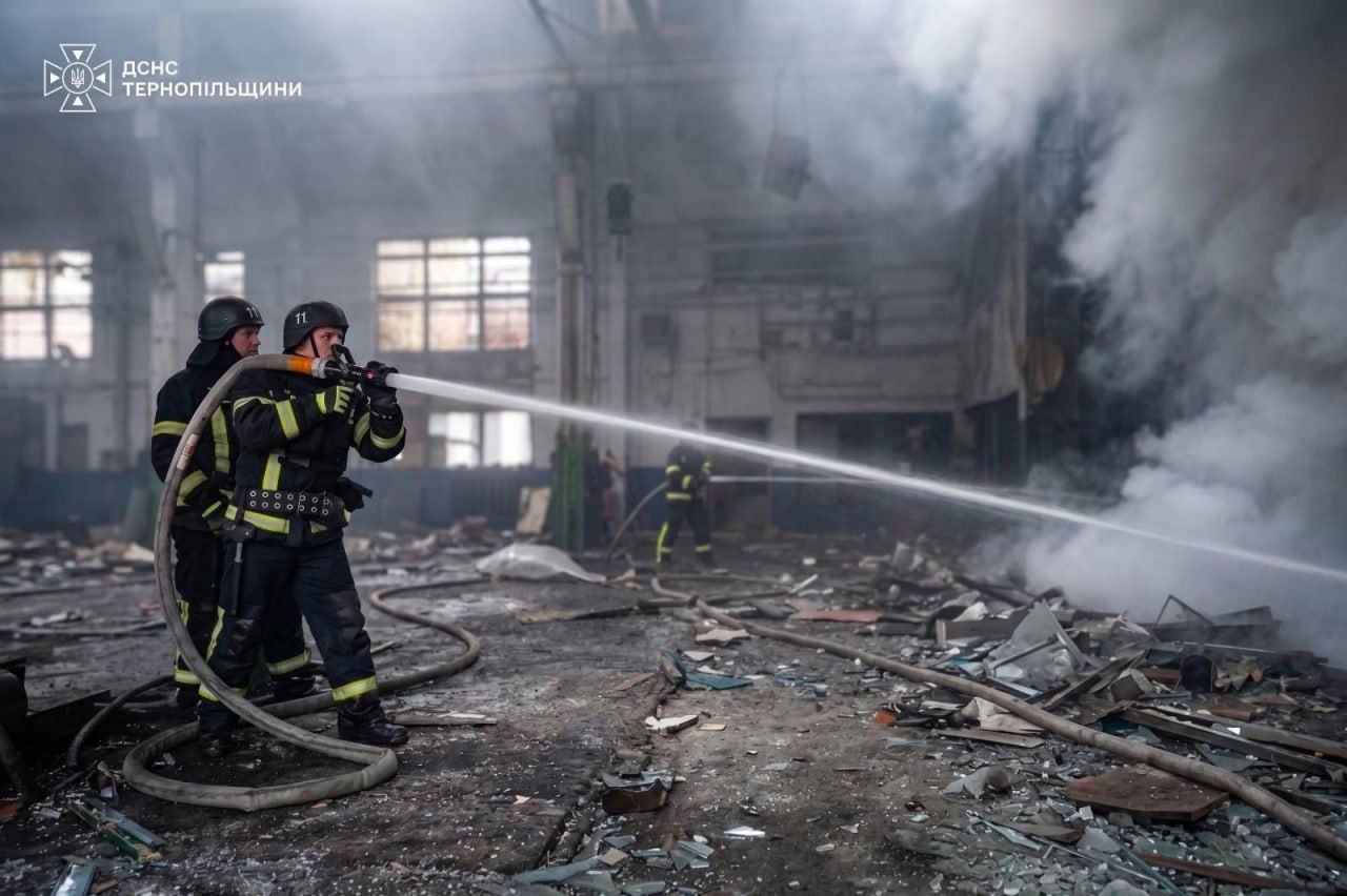 Firefighters extinguish a blaze following Russian drone attacks in western Ukraine, Sept. 13, 2026
